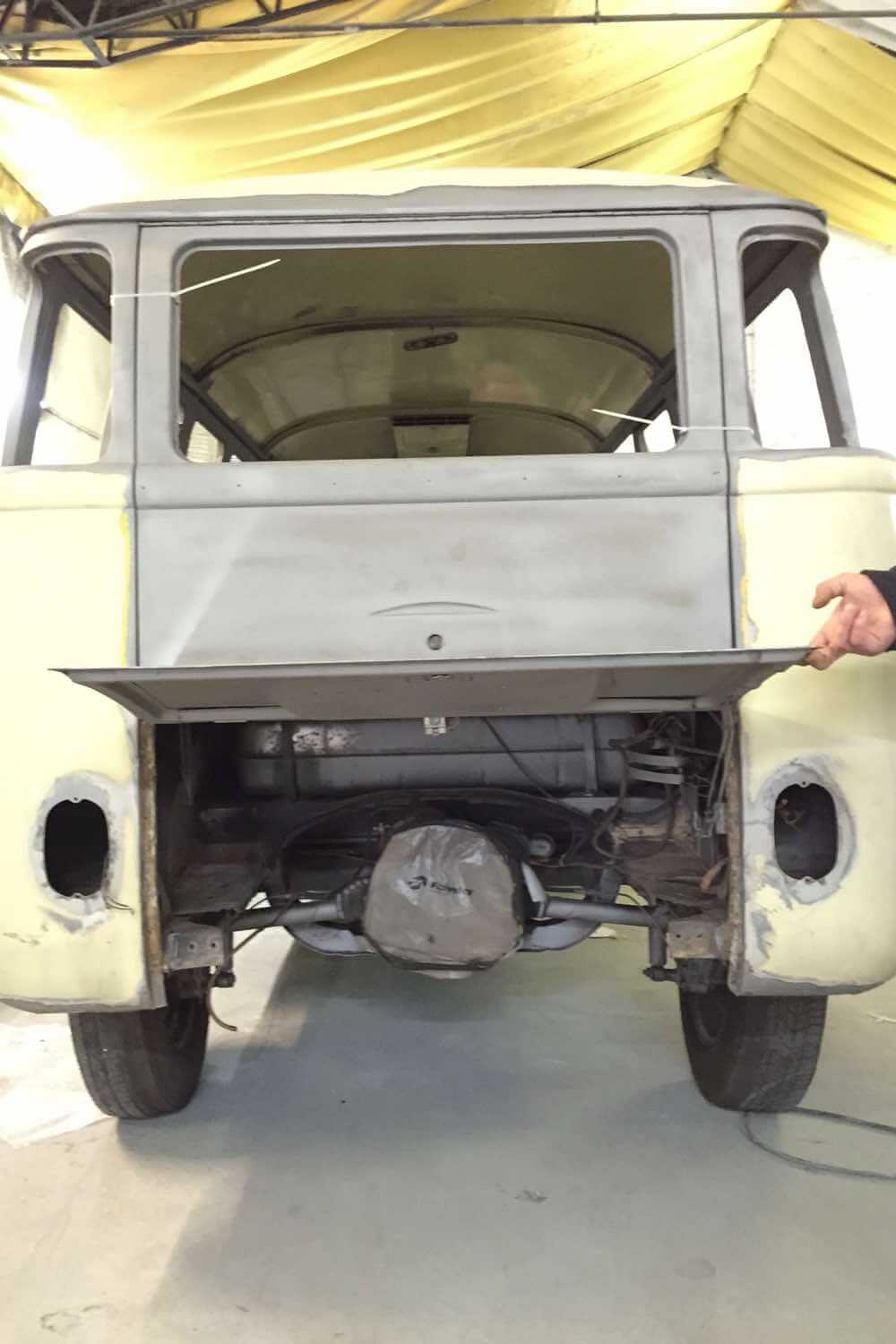 Geöffnete Heckklappe eines VW T1 während der Restaurierung mit Blick auf den luftgekühlten Boxermotor